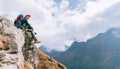 Young hiker backpacker female sitting on cliff edge and enjoying the Imja Khola valley during high altitude Everest Base Camp EBC Royalty Free Stock Photo
