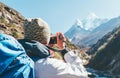 Young hiker backpacker female taking photo mountain view during high altitude Acclimatization walk. Everest Base Camp trekking