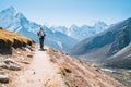 Young hiker backpacker female taking a walking with trekking poles during high altitude Everest Base Camp route near Dingboche, Royalty Free Stock Photo