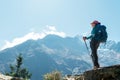 Young hiker backpacker female using trekking poles enjoying mountain view during high altitude Acclimatization walk. Everest Base Royalty Free Stock Photo