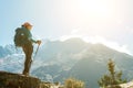 Young hiker backpacker female using trekking poles enjoying mountain view during high altitude Acclimatization walk. Everest Base