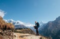 Young hiker backpacker man with trekking poles enjoying the Ama Dablam 6814m peak mountain during high altitude acclimatization