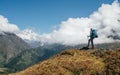 Young hiker backpacker man using trekking poles enjoying the Nuptse 7861m mountain during high altitude Acclimatization walk. Royalty Free Stock Photo