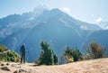 Young hiker backpacker man using trekking poles enjoying the Thamserku 6608m mountain with flying rescue helicopter during high