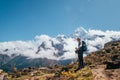 Young hiker backpacker man using trekking poles enjoying the Thamserku 6608m mountain during high altitude Acclimatization walk.