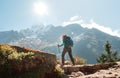 Young hiker backpacker woman using trekking poles enjoying Everest Base Camp trekking route with Thamserku 6608m mountain on