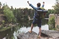 young hiker raising fists while looking Royalty Free Stock Photo