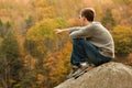Young hiker relaxing on rock