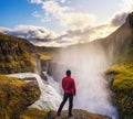 Young hiker standing at the edge of the Gullfoss waterfall in Iceland