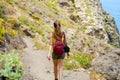 Young hiker woman back view walking on mountain path Royalty Free Stock Photo