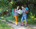 Young Hikers looking into Map on Forest Trail Royalty Free Stock Photo