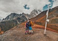 Young hiking couple in Guli Pass under the double peak Ushba in Svaneti region of Georgia Royalty Free Stock Photo