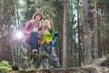 Young hiking couple with map discussing over direction in forest Royalty Free Stock Photo