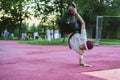 Young hip hop street dancer in the city during the dusk doing freeze