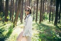 Young hippie woman walks in the summer forest laughs dances and enjoys life and nature Royalty Free Stock Photo