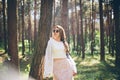 Young hippie woman walks in the summer forest laughs dances and enjoys life and nature Royalty Free Stock Photo