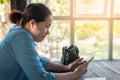 Young hipster Asian woman with mobile phone