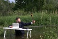 Young hipster bearded guy, goofing off, having fun in the workplace and taking a selfie Royalty Free Stock Photo