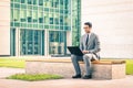 Young hipster business man with laptop at business center Royalty Free Stock Photo