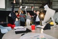 Young hipster business people excited happy smile, throw papers, documents fly in air, hold hands arms up, success team Royalty Free Stock Photo