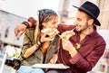 Young hipster couple eating pizza at bar restaurant outdoors - Happy relationship concept with millenial boyfriend and girlfriend Royalty Free Stock Photo