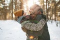 Young hipster couple hugging each other in winter forest Royalty Free Stock Photo