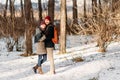 Young hipster couple hugging each other in winter park. Winter love story, a beautiful stylish young couple Royalty Free Stock Photo