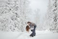 Young hipster couple hugs each other in a winter park. Winter holidays. Christmas holidays outdoors in the forest Royalty Free Stock Photo