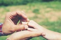 Young hipster couple wearing engagement ring in nature,Sweet and Royalty Free Stock Photo