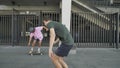 Young hipster is doing skateboard trick in daytime in summer, man with camera is following him and doing video, sport