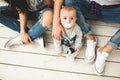 Young hipster father, mother and baby boy on wooden floor