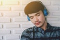 Young hipster gay man listening music headphones. Royalty Free Stock Photo