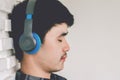 Young hipster gay man listening music headphones. Royalty Free Stock Photo