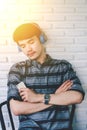 Young hipster gay man listening music headphones. Royalty Free Stock Photo