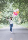 Young hipster girl holding balloon walk on the road, Royalty Free Stock Photo