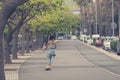 Young hipster girl is skating on skateboard.