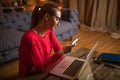 Young hipster girl in stylish casual red sweater holding mobile phone with empty mock up copy space screen Royalty Free Stock Photo