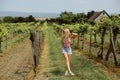 Young hipster girl is walking through the vineyard in the countryside. Royalty Free Stock Photo