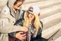 Young hipster happy couple with computer laptop in urban area