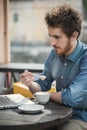 Young hipster having a coffee at the bar Royalty Free Stock Photo