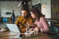 Young hipster male and female working laptop together in cafe Royalty Free Stock Photo