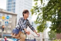Young hipster man with bag riding fixed gear bike Royalty Free Stock Photo