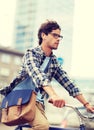 Young hipster man with bag riding fixed gear bike Royalty Free Stock Photo