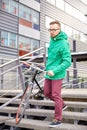 Young hipster man carrying fixed gear bike in city Royalty Free Stock Photo