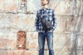 Young hipster man in casual wear with stylish leather crossbody Royalty Free Stock Photo