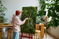 Young hipster man designer creating floral composition at art studio