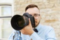 Young hipster man with digital camera in city Royalty Free Stock Photo