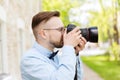 Young hipster man with digital camera in city Royalty Free Stock Photo