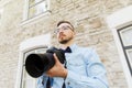 Young hipster man with digital camera in city Royalty Free Stock Photo