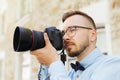 Young hipster man with digital camera in city Royalty Free Stock Photo